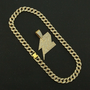 Close-up of hip hop gold pendant featuring iced-out lightning bolt and Cuban link chain