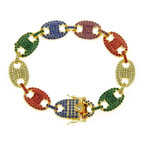Macro view of gold hip hop bracelet featuring colorful rhinestones and pig nose clasp