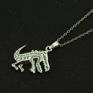 Chic silver dinosaur pendant necklace with colorful stripes on a dark background