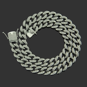 Detailed view of silver Cuban link necklace with micro-paved cubic zirconia stones and box clasp