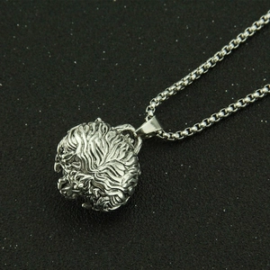 Detailed macro view of vintage lion head cremation pendant with engraved mane texture