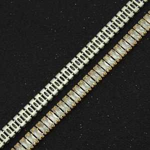 Macro shot of rectangular baguette-cut cubic zirconia in gold and silver plated bracelets