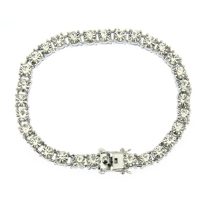 Detail view of silver tennis bracelet with round cubic zirconia and secure safety clasp