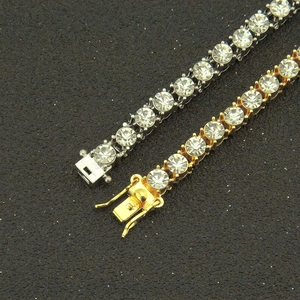 Macro shot of gold and silver tennis bracelets showing secure box clasp and crystal details