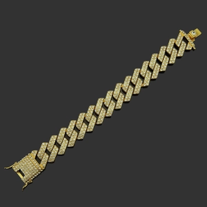 Macro detail of 20mm wide gold plated iced-out Cuban chain bracelet for men with white zircon