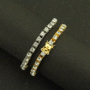 Classic tennis bracelet featuring single row of round crystals in gold and silver finish