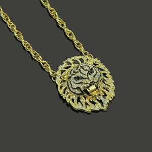 Macro shot of hip hop tiger head pendant with white rhinestones and gold rope chain