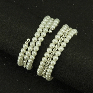 Elegant multilayer pearl bracelet with sparkling rhinestones on a black background