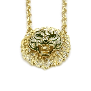 Detailed close-up of golden hollow lion head pendant with micro-pave white rhinestones
