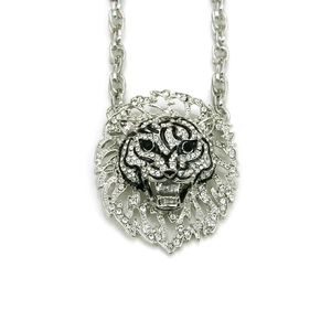 Detailed view of silver lion head pendant with sparkling white rhinestones and link chain