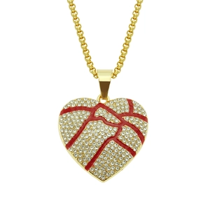Macro shot of hip hop gold heart pendant with red crackle enamel and white crystals