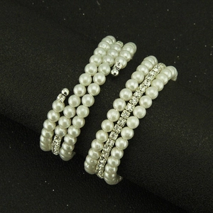 Three-layer spiral bangle with white pearls and sparkling rhinestones for bridal fashion