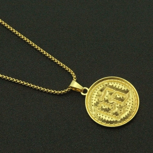 Macro shot of 18K gold plated hiphop medallion necklace with intricate relief and box chain