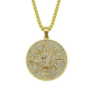 Macro detail of gold-plated number 7 pendant necklace with iced-out crystals on box chain