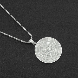 Close-up of hip hop silver necklace with round diamond pendant featuring letter A