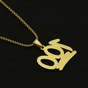 Detailed macro shot of gold-plated number 99 pendant with textured micro-pave surface