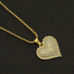 Elegant heart-shaped pendant necklace with sparkling diamonds on a gold chain