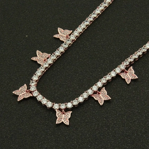 Rose gold butterfly necklace featuring cubic zirconia micro-pave charms on a tennis chain