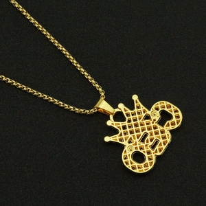 Vue détaillée du pendentif couronne dorée avec dos en maille et chaîne à maillons métal