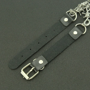Close-up of gothic leather choker with silver thorn chain and metal buckle detail