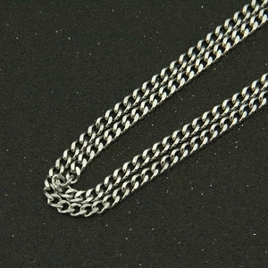 Close-up of polished silver stainless steel curb chain with high gloss metal links
