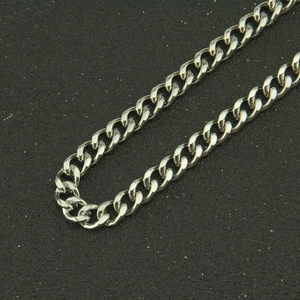Detailed macro view of polished silver Cuban link chain with glossy metallic finish