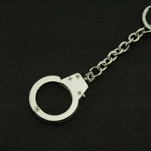 Punk style silver metal handcuff keychain with a bead chain and industrial design