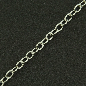 Macro close-up of a polished silver stainless steel link chain on black background