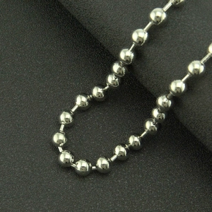 Macro shot of silver metal bead chain with smooth polished finish and punk style detailing