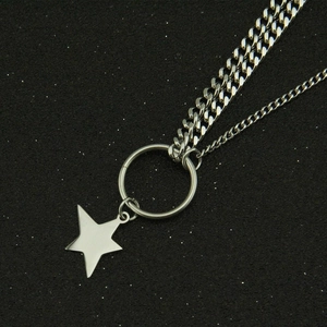 Silver star pendant necklace featuring layered Cuban and snake chain with a glossy finish