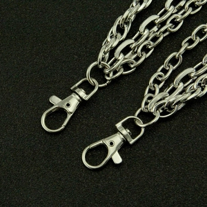 Multi-layer silver metal punk pants chain with bullet accents on a textured black surface
