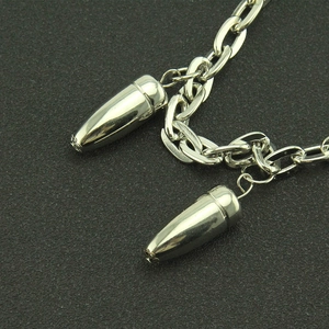Macro detail of punk style silver metal trousers chain with bullet shaped pendants