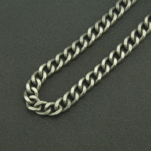 Detail of dark gray matte metal curb chain with a vintage industrial finish