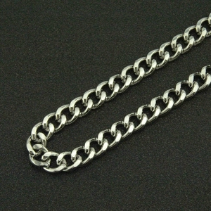 Detailed close-up of a polished silver curb chain with high-gloss metallic finish