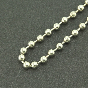 Macro view of polished silver bead chain with spherical bamboo style metal link texture