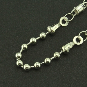 Macro shot of silver metal ball chain detail with polished stainless steel eyelets