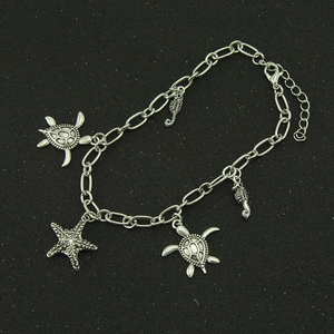 Retro silver marine bracelet featuring turtle, starfish and seahorse charms on black base