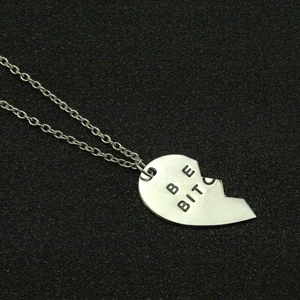Minimalist silver split heart pendant necklace with BE BITC engraved lettering