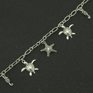 Retro silver marine charm bracelet with vintage turtle, seahorse, and starfish pendants