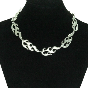 Close-up of gothic punk flame-shaped silver metal necklace on a black jewelry bust