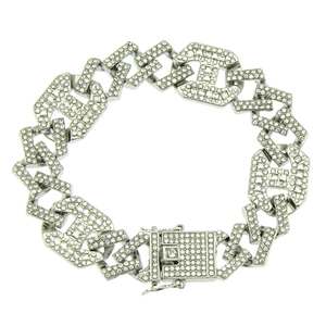 Macro detail of silver-tone iced out Cuban link bracelet with H-shaped crystal links