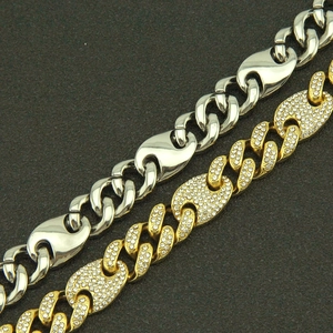Macro shot of silver metal and gold iced-out coffee bean link necklaces with cubic zirconia