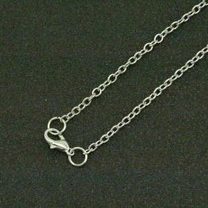 Macro shot of a silver flame necklace chain with a durable lobster clasp and O-ring detail