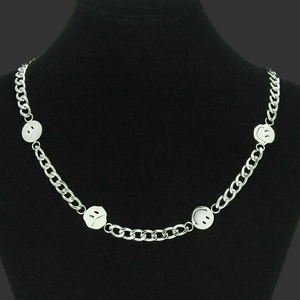 Silver chunky chain necklace with smiley face pendants on a black jewelry display
