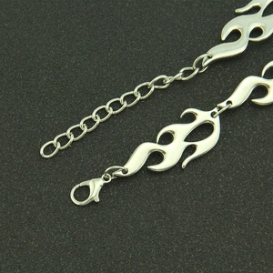 Close-up of silver flame-shaped necklace links with lobster clasp and extension chain