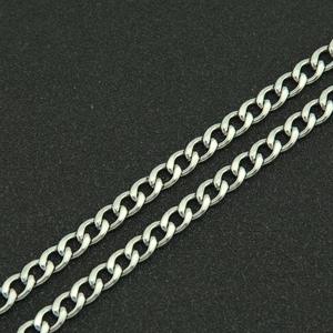 Close-up of polished silver stainless steel Cuban link chain with detailed interlocking rings