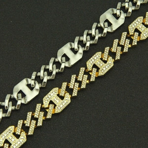 Detail of silver textured and gold iced-out Cuban chain bracelets with rhinestones