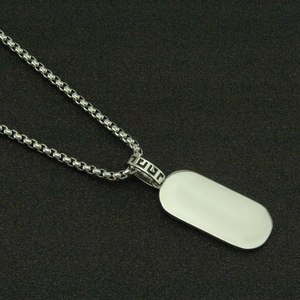 Detail of silver box chain with rectangular pendant and Greek key pattern bail