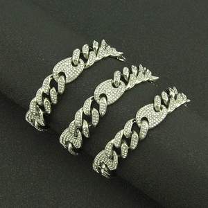 Three rows of hip hop silver cuban link necklaces with iced out rhinestones on black display