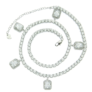 Detailed close-up of a silver tennis chain with rectangular emerald-cut zircon stones